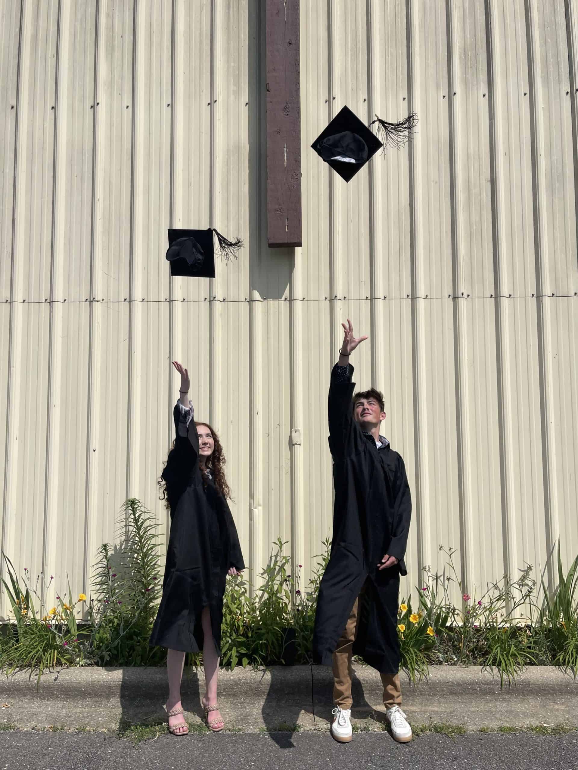 Graduates throwing cap in air